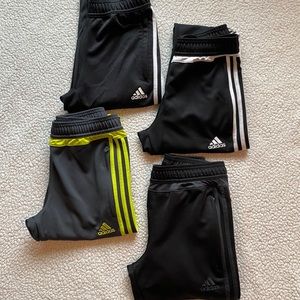 4 pair of youth unisex Adidas Tiro training pants.